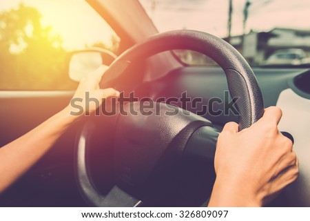 Woman driving car in vintage filter effect.