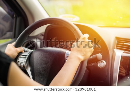 Woman driving car. Vintage filter