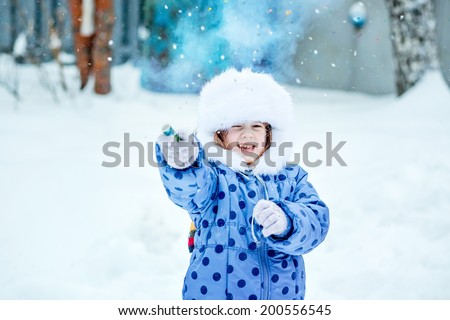 Young girl pulling a Christmas party poppers.