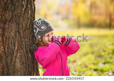 Surprised girl near a large tree. Ecological concept. Instagram filter.