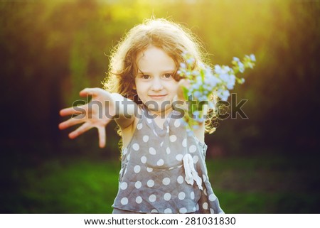 A little girl gives a bouquet to his mother or father. Mum, Dad\'s Day concept. Toning for instagram filter.
