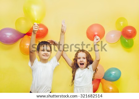 Happy children with balloons at happy birthday party.