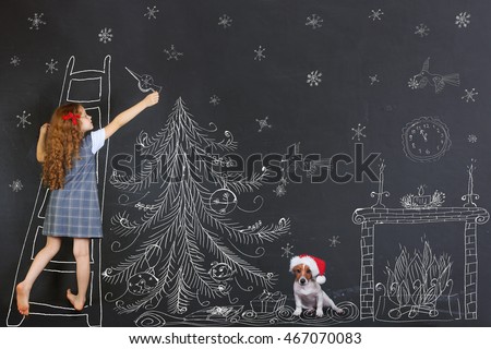 Child and her puppy decorates a Christmas tree drawing on blackboard. Christmas holiday concept.