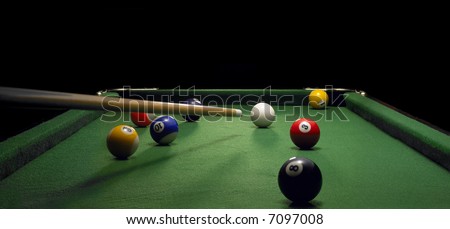 pool table with cue ready to play the white ball