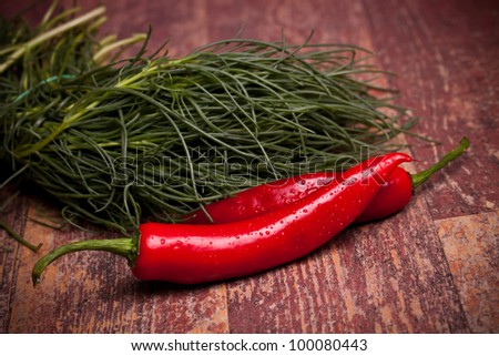 Food Ingredients - Vegetables - Bunch of salsola soda (Italian agretti) and chili peppers.