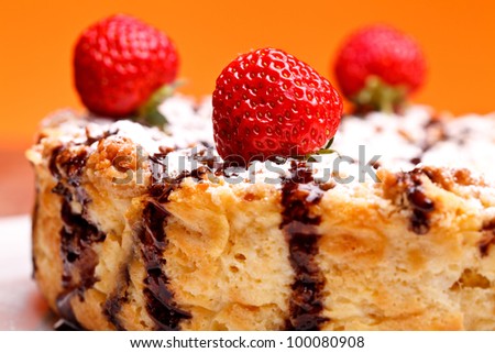 American Cuisine - Desserts - Closeup of cheescake with chocolate decorated with strawberries.