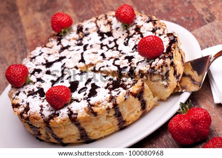 American Cuisine - Desserts - Cheescake with chocolate decorated with strawberries.