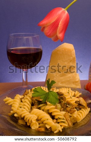 Food & Drinks - Italian Cuisine. Plate with fusilli and champignons, glass of wine, piece of parmesan.