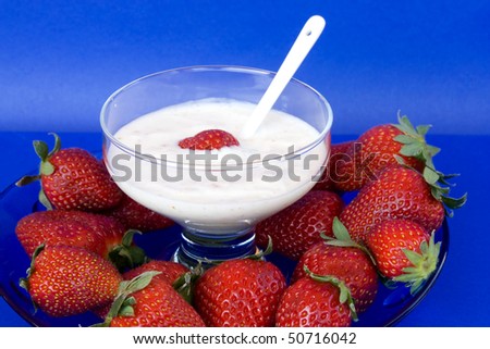 Food & Drinks - Desserts. Bowl of yogurt with strawberries.