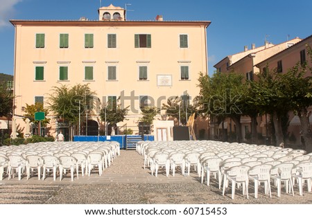 Empty chairs in the Church Square, Marciana Marina, Elba Island, Italy.
