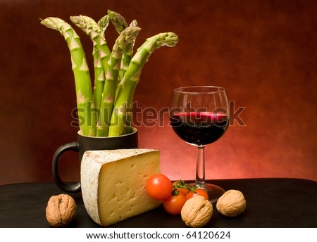 Food - Still life with asparagus, cheese, wine, nuts and cherry tomatoes.