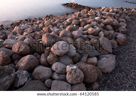 Nature - Stones on the beach in the purple light at dusk - Punta Ala, Tuscany, Italy.