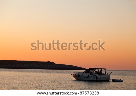Boat In The Sea At Sunrise - Boat at sunrise ion the coast of Giannutri island, Tuscan Archipelago, Italy.