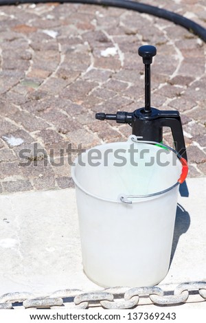 Equipment for washing the boat deck: bucket and water sprayer.