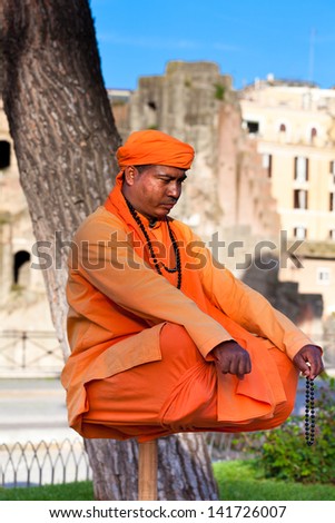 ROME, ITALY - APRIL 11:  - Mystery and magic. Man sitting on a top of a stick, seem to sit in the air, evoking spiritual magic and mystery of Indian origin. - April 11, 2013, in Rome.