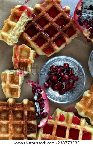 Overhead shot of golden fresh baked waffle topped with pomegranate sorbet.