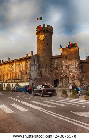 BAGNAIA, LAZIO, ITALY - JANUARY 10, 2015: People meet in the main square of Bagnaia at dusk. Bagnaia is a little town in Viterbo province, Lazio, Italy.