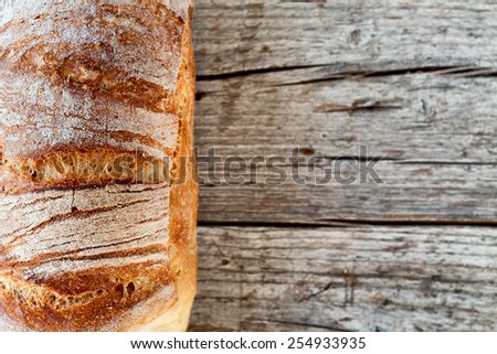 Closeup of ciabatta typical Italian bread, overhead shot on wood background.