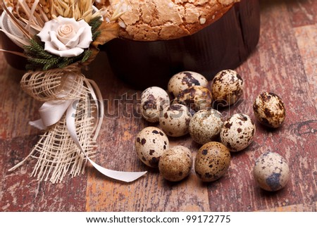 Easter still life with quail eggs and Easter dove on wood table.