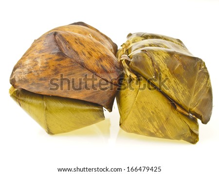 banana leaf color of  Khao Tom Mat pack on white background. Khao Tom Mat is thai dessert. it make from sticky-rice sugar banana and wrap in banana leaf. final is cooked with steam