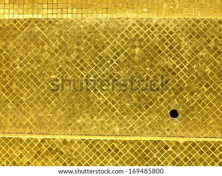 surface of golden tile decoration at stupa base. grand palace, Phrakaew temple, Bangkok, Thailand