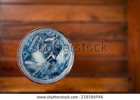 glass of blue curacao on table from top view