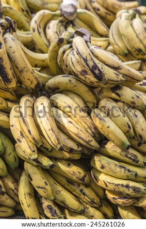 pile of a hand of bananas on stall in street market, Delhi, India