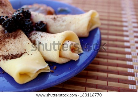 Crepes covered with blackberries and filled with jam