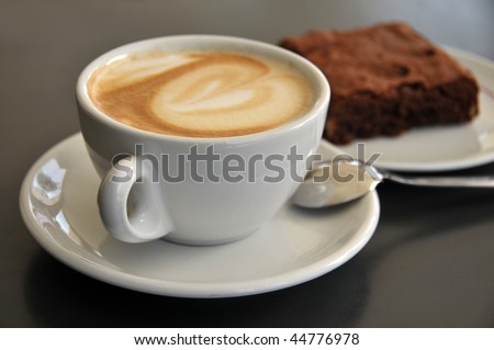 Closeup of coffee cup and brownies on a table