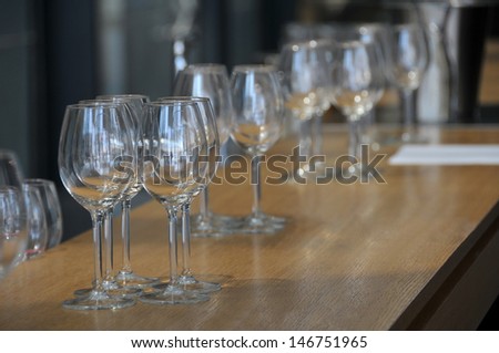 View of few wineglasses on a wood table before banquet.