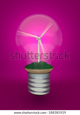 Wind turbine on the grass inside light bulb, eco light bulb