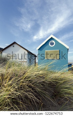 Beach huts in sand dunes at Mudeford Spit on Hengistbury Head near Christchurch in Dorset.