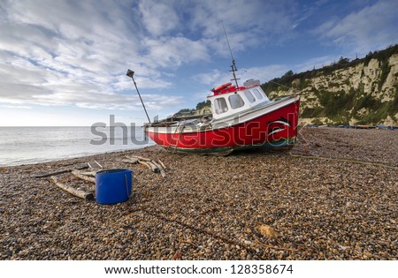 Red fishing boat on the beach at Beer on the Jurassic Coast in Devon