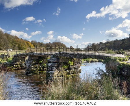 A granite clapper bridge across the river Dart at Postbridge on Dartmoor National Park in Devon