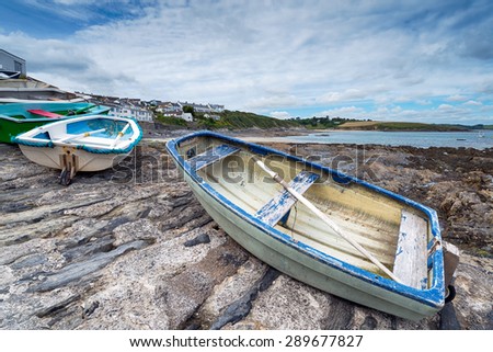 Small rowing boats lined up on the slipway at Portscatho on the Roseland Peninsula in Cornwall
