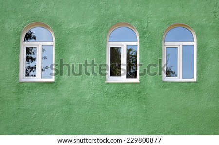 arched windows on green wall