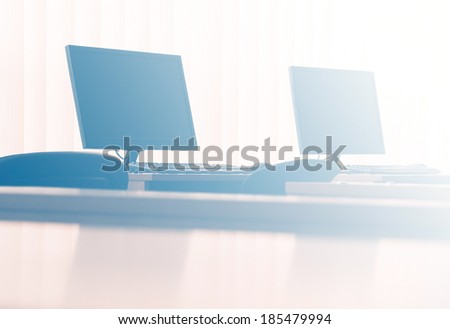 Computers in office - light filtered background