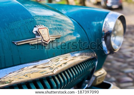 LVIV, UKRAINE - APR 15: Closeup of Gorky Automobile Plant logo on vintage cyan blue GAZ-M-21 Volga car (released circa 1965 in USSR) parked at Yaponska street on April 15, 2014 in Lviv, Ukraine.