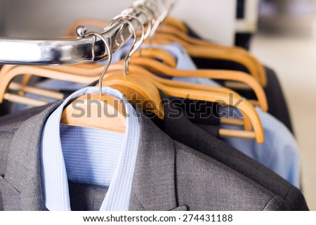 Mens suits on hangers in a clothes store