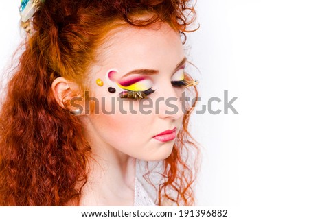 Side profile young model with professional makeup and with climbing red hair isolated on white background