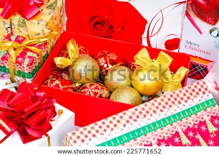 Preparations for the Christmas holiday. Gifts in festive packaging, decoration for Christmas tree, shiny balls with bows