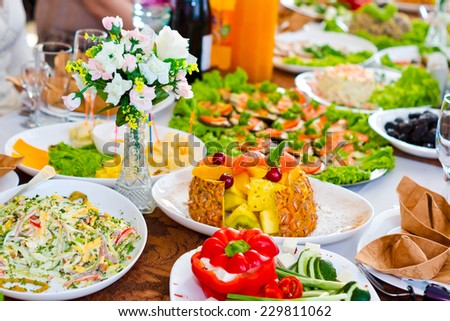 Festively laid table with snacks, fruit a variety of cooked dishes