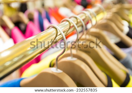 Clothes hang on a shelf in a designer clothes store