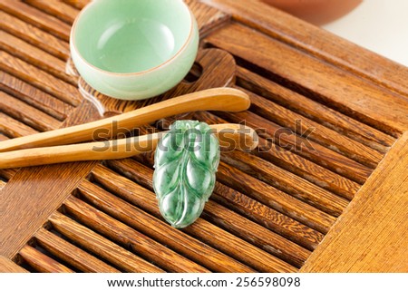 green gemstone on wooden board
