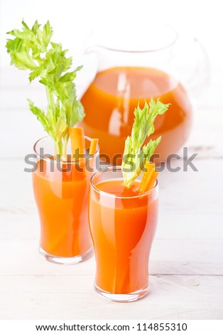 Fresh carrot and pumpkin juice on white background