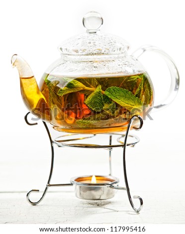 Herb tea time: teapot with sprigs of mint
