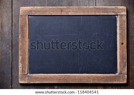 Vintage slate chalk board on wooden background