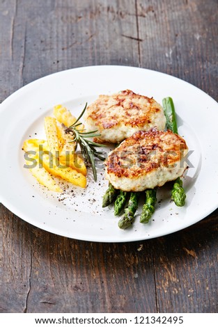 Fishcakes with french fries and asparagus