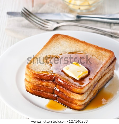 Golden brown french toast with syrup and butter