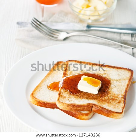 Golden brown french toast with syrup and butter